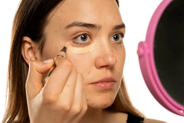 Young Women Applying Concealer Her Eyes Face White Background — Foto de Stock