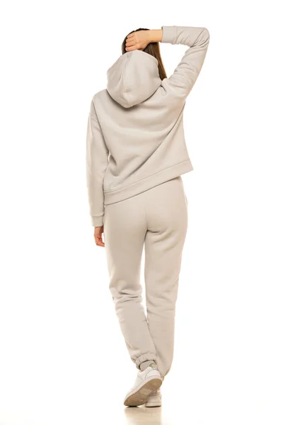 Rear View Young Woman Gray Tracksuit Hood Posing White Background — Zdjęcie stockowe