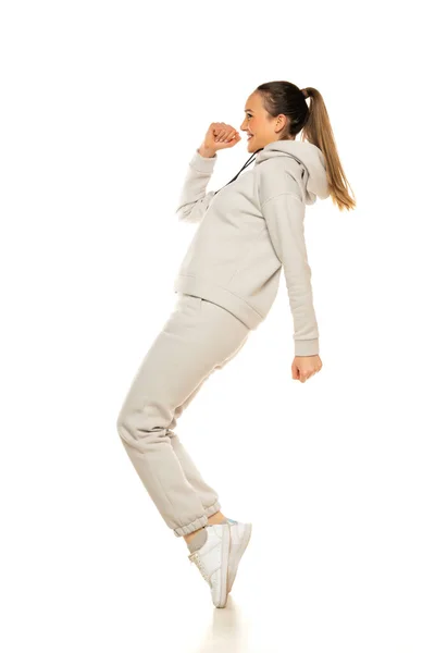 Young Woman Gray Tracksuit Poses White Background Studio — Foto Stock