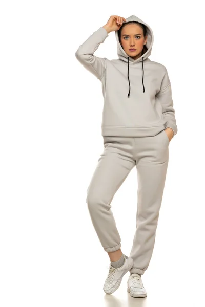 Front View Young Woman Gray Tracksuit Hood Posing White Background — Foto de Stock
