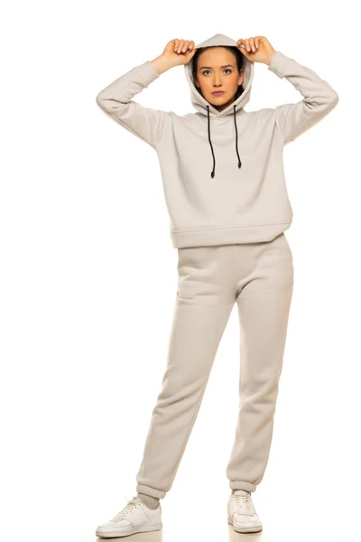 Front View Young Woman Gray Tracksuit Hood Posing White Background — Stockfoto