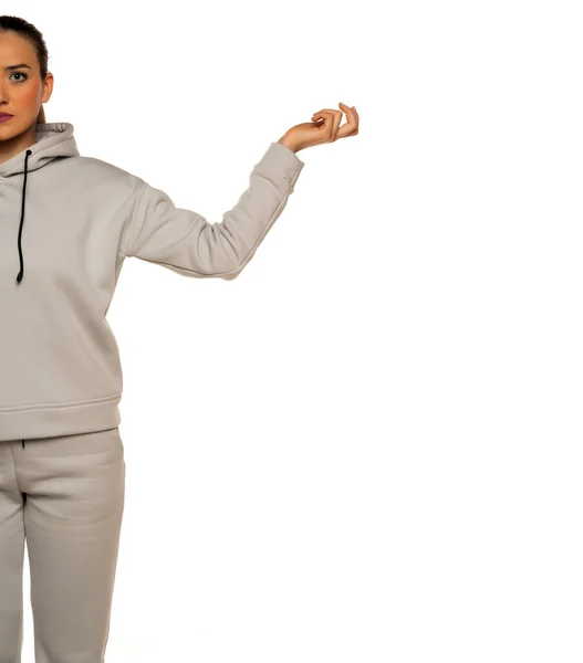 Half Portrait Young Woman Tracksuit Outstretched Hand White Background — Foto Stock