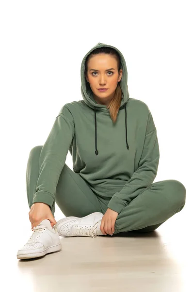 Portrait Young Woman Sports Clothes Hood Sitting Posing Studio White — Φωτογραφία Αρχείου