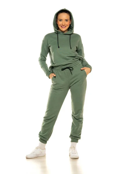 Front View Young Happy Woman Green Tracksuit Hood Posing White — стоковое фото