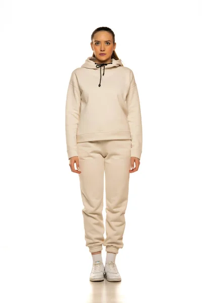 Front View Young Woman Beige Tracksuit Posing White Background Studio — стоковое фото