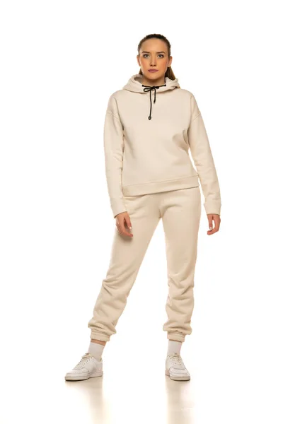 Front View Young Woman Beige Tracksuit Posing White Background Studio — Φωτογραφία Αρχείου