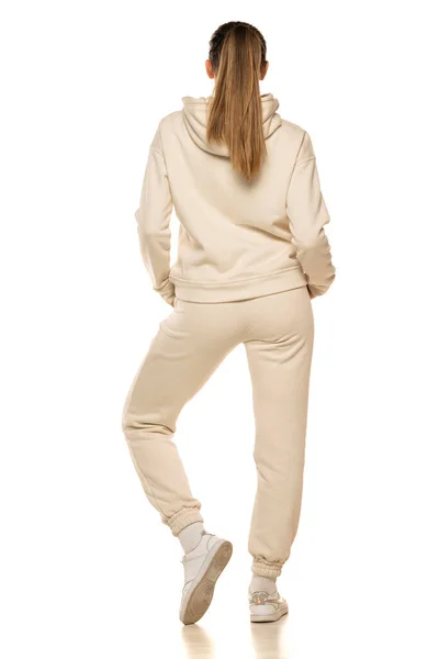 Rear View Young Woman Beige Tracksuit Posing White Background Studio — стоковое фото