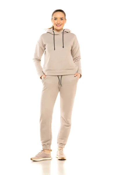 Front View Young Smiling Woman Gray Tracksuit Posing White Background — Foto Stock