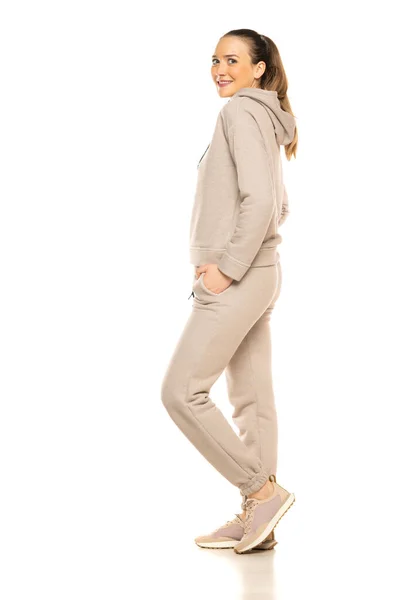 Side View Young Smiling Woman Gray Tracksuit Posing White Background — стоковое фото