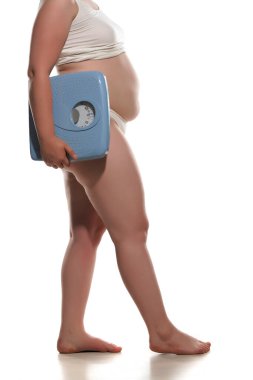 Big fat woman carrying large old bathroom scale.