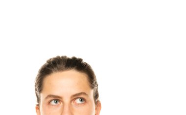 closeup portrait headshot cropped face above lips of cute puzzled woman with blue eyes looking up isolated on white studio wall background with copy space above head. Human face expressions, emotions.