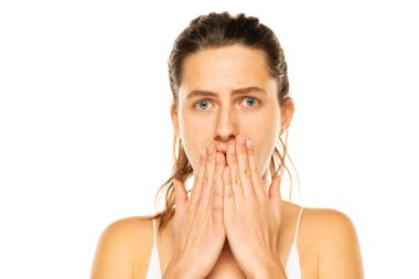 Image of shocked young lady with blue eyes, posing isolated over white background.