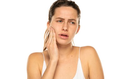 Young woman with toothache on a white background.