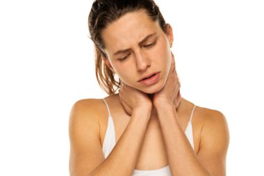 Young woman with neck pain on a white background.