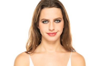 Beautiful serious woman with make up fake smile on a white background.