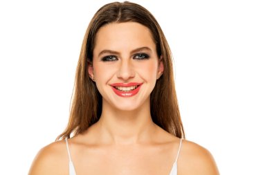 Beautiful smiling woman with make up and long hair on a white background.