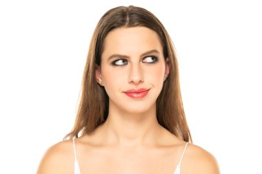 Image of thinking young lady with blue eyes, posing isolated over white background. Looking aside.