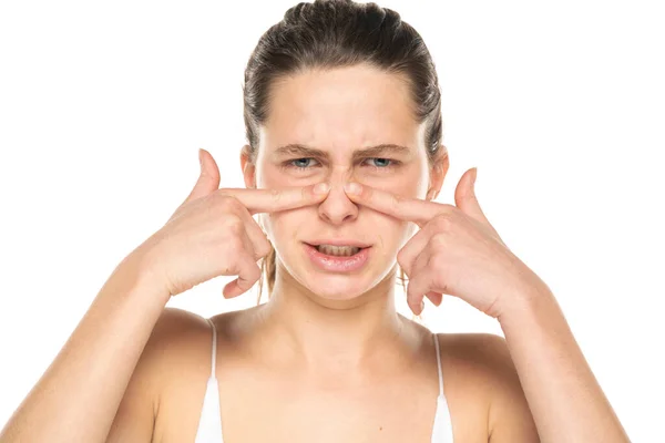 Young Woman Press Her Nose Her Fingers White Background — Foto de Stock