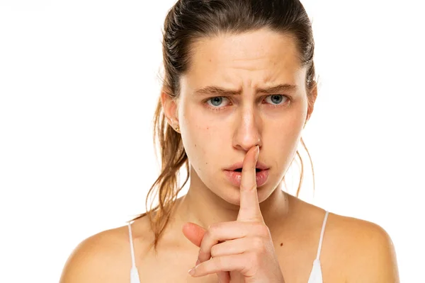 Close Young Frowning Woman Holding Finger Lips White Background — Foto Stock