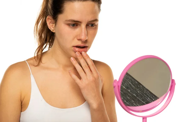 Worried Young Woman Front Mirror Touches Her Mouth White Background — Stok Foto