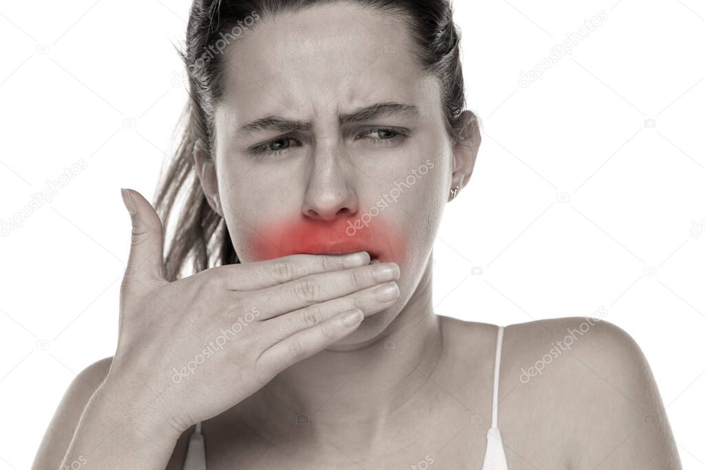 Young woman with toothache on a white background.