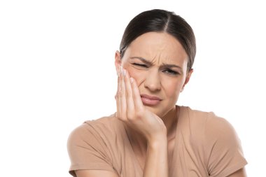 Beautiful young woman with strong toothache on a white studio background