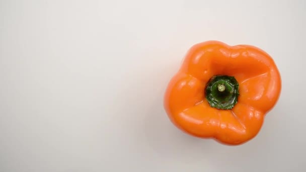 Rotating Orange Pepper Against White - Overhead Dolly Right — Stock Video