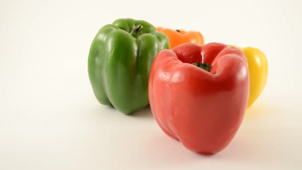 Red, Green, Yellow and Orange Peppers Against White - Diamond Arrangement - Dolly Left — Stock Video