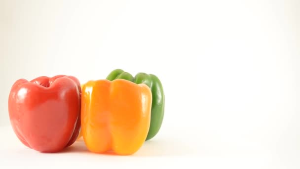 Rotating Red, Yellow, Orange and Green Peppers Against White - Crane Down — Stock Video