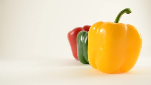 Yellow, Green and Red Peppers Against White - Line Arrangement - Crane Up — Stok video