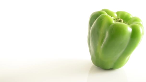 Rotating Green Pepper On Acrylic Against White - Crane Down — Stock Video