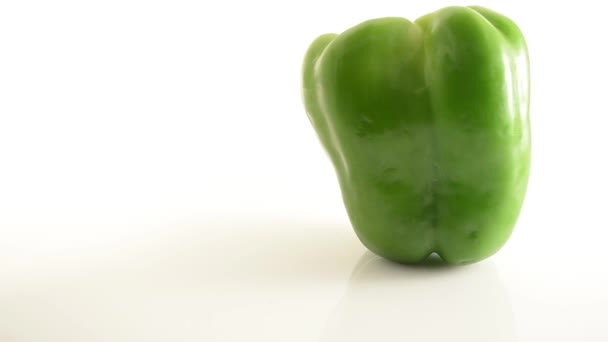 Rotating Green Pepper On Acrylic Against White - Crane Up — Stock Video