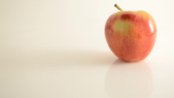 Rotating Royal Gala Apple On Acrylic Against White - Crane Up — Stock Video