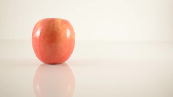 Pink Lady Apple On Acrylic Against White - Dolly Right — Stock Video