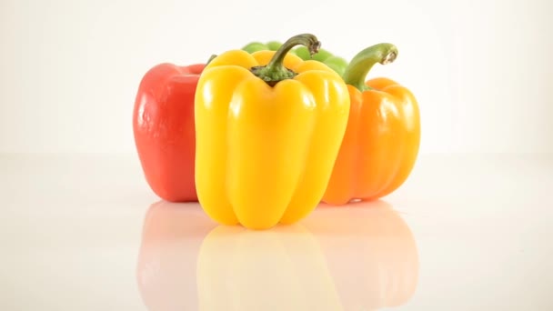 Peperoni gialli, verdi, arancioni e rossi su acrilico contro il bianco - Disposizione diamante - Dolly destra — Video Stock