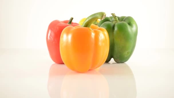 Orange, Yellow, Green and Red Peppers On Acrylic Against White - Diamond Arrangement - Dolly Right — Stock Video