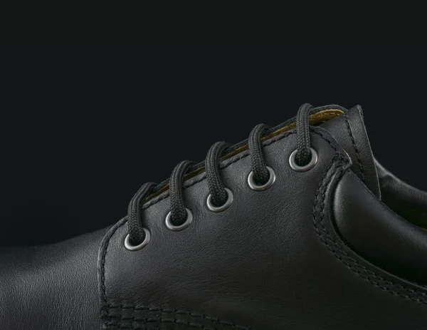 Black men's shoe on black background — Stock Photo, Image