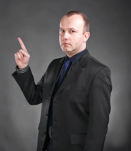 Young man pointing upwards — Stock Photo, Image