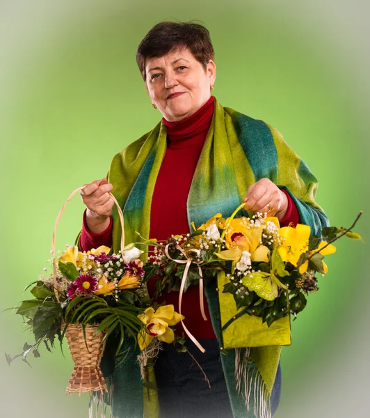 Senior woman with bouquets of flowers — Stock Photo, Image