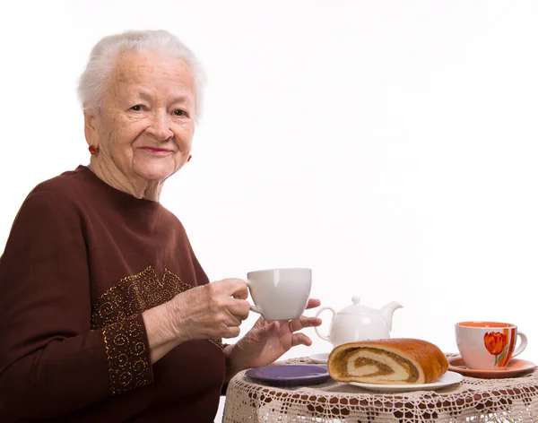 Old woman having breakfast — Stok fotoğraf