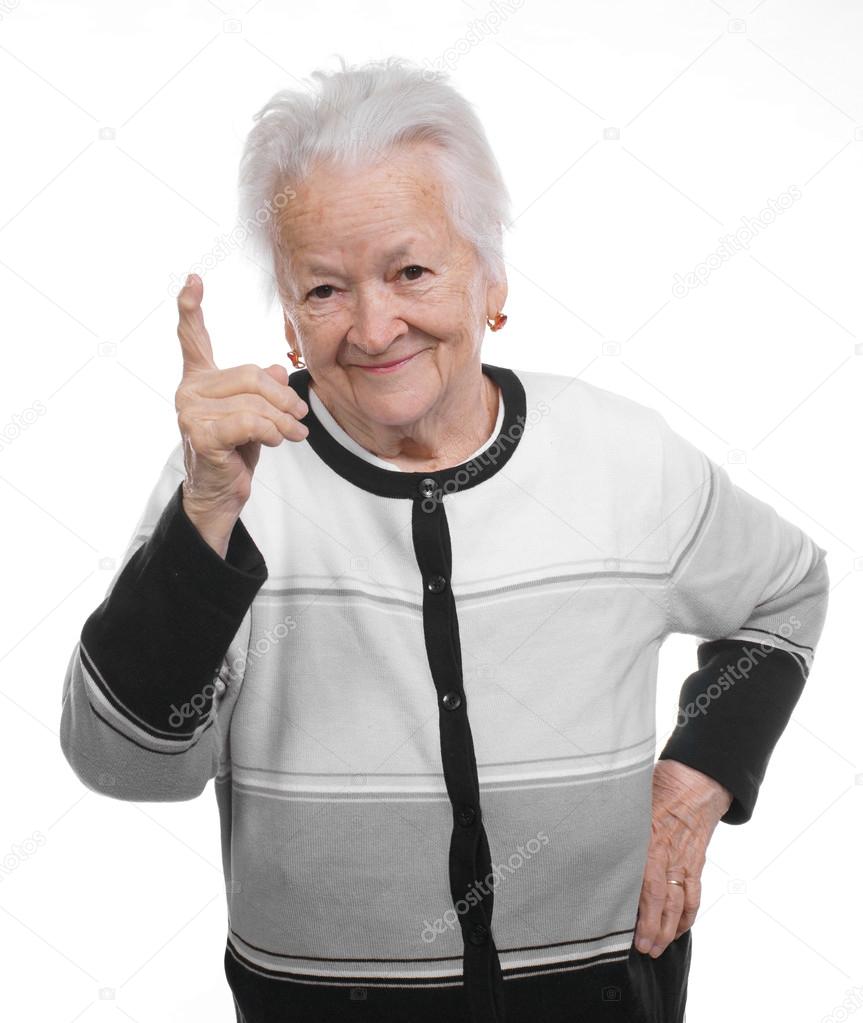 Portrait of a happy old woman pointing upwards