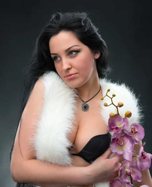 Beautiful woman with lilac orchid — Stock Photo, Image