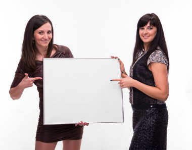 Portrait of two young women with billboard