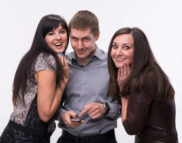 Group of surprised looking at a cell phone — Stock Photo, Image