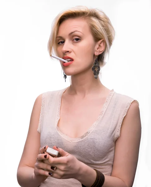 Emotional sexy woman posing with cigarette and matches — Stock Photo, Image