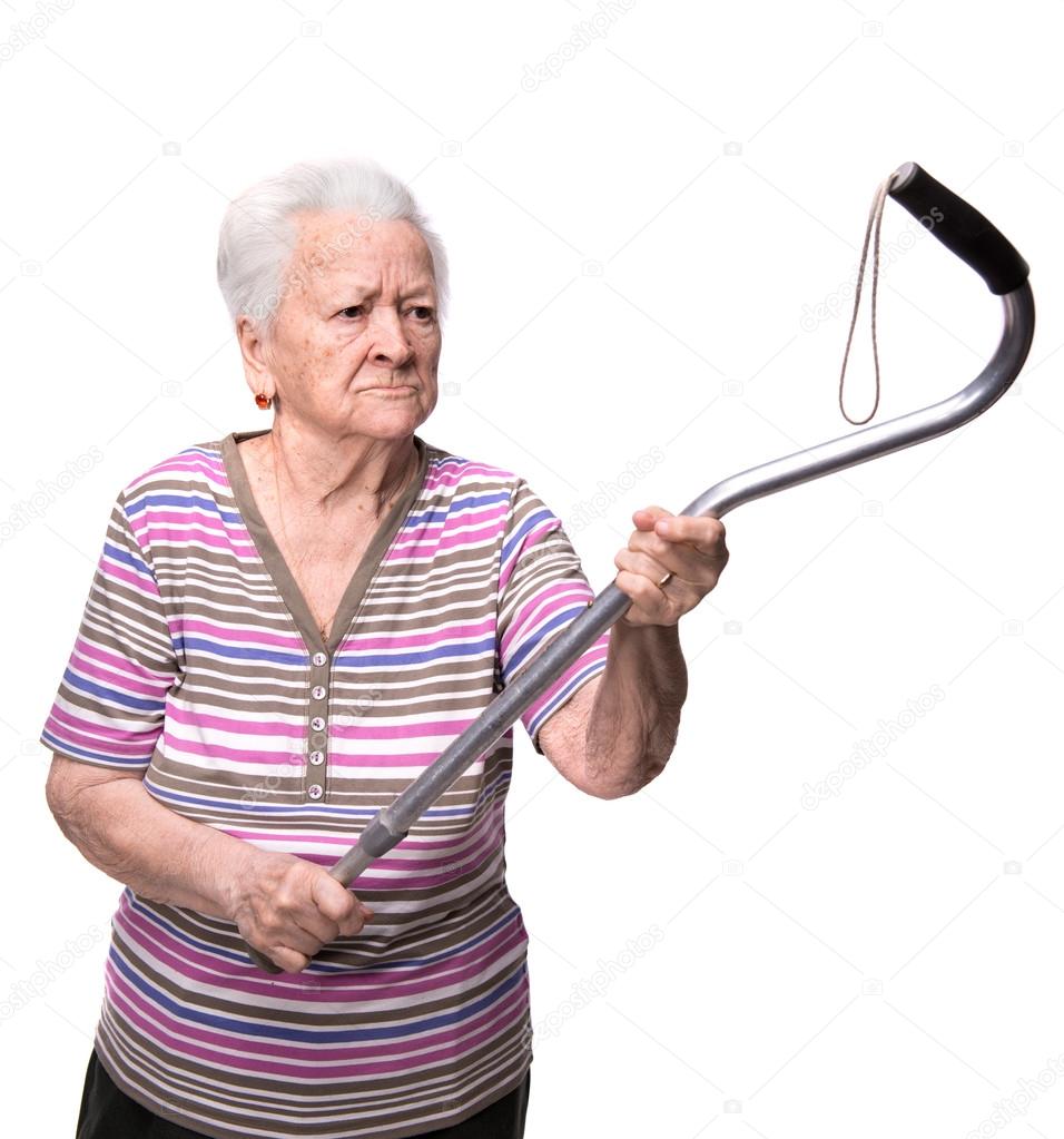 Old angry woman threatening with a cane
