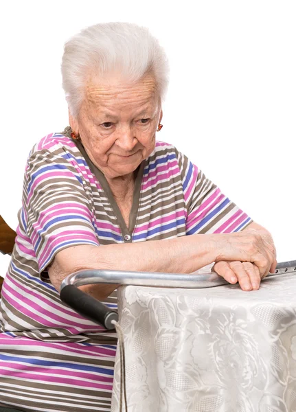 物思いにふける古い女性のテーブルに座って — ストック写真