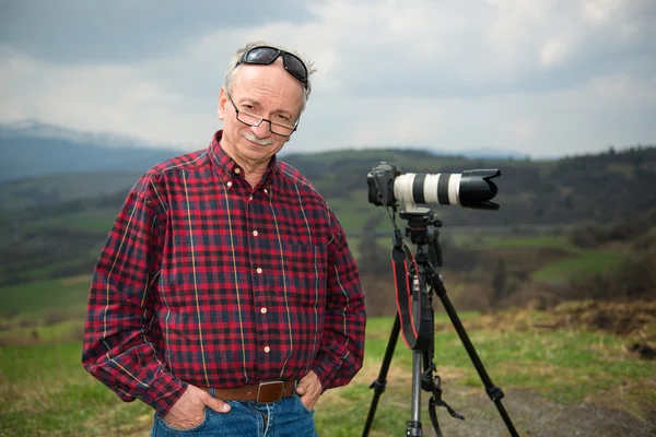 Senior photographer with camera — Stock Photo, Image