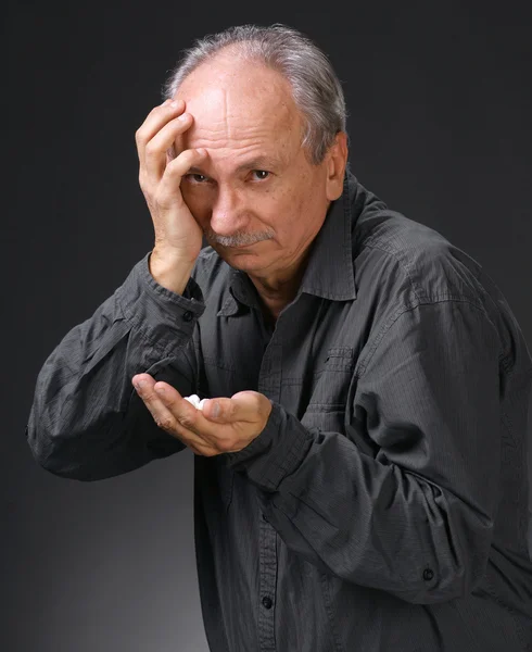 Man holding handful of pills — Stock Photo, Image