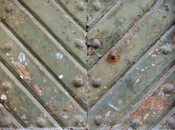 Ancient weathered door background texture with metal rivets — Stock Photo, Image